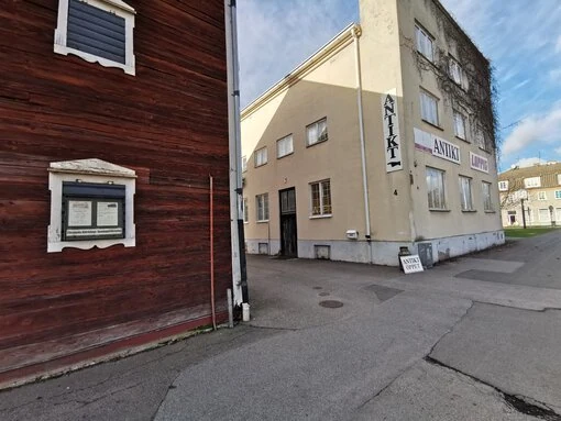 En gata med entrén till Epokernas Antik och skyltar som visar vägen.